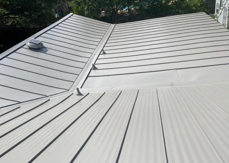 Solar attic fan installed on a metal roof for Roof Ventilation in Four Square Mile